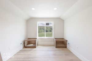 Bright room featuring a central window, recessed lighting, and light wood-finish flooring
