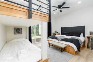 Bedroom featuring a wood-finish floor and white walls