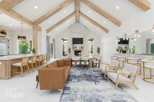 Vaulted ceilings with exposed wood beams define this open-concept living space