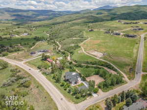 Expansive property featuring a large residence, separate outbuilding, and significant acreage with paved road frontage