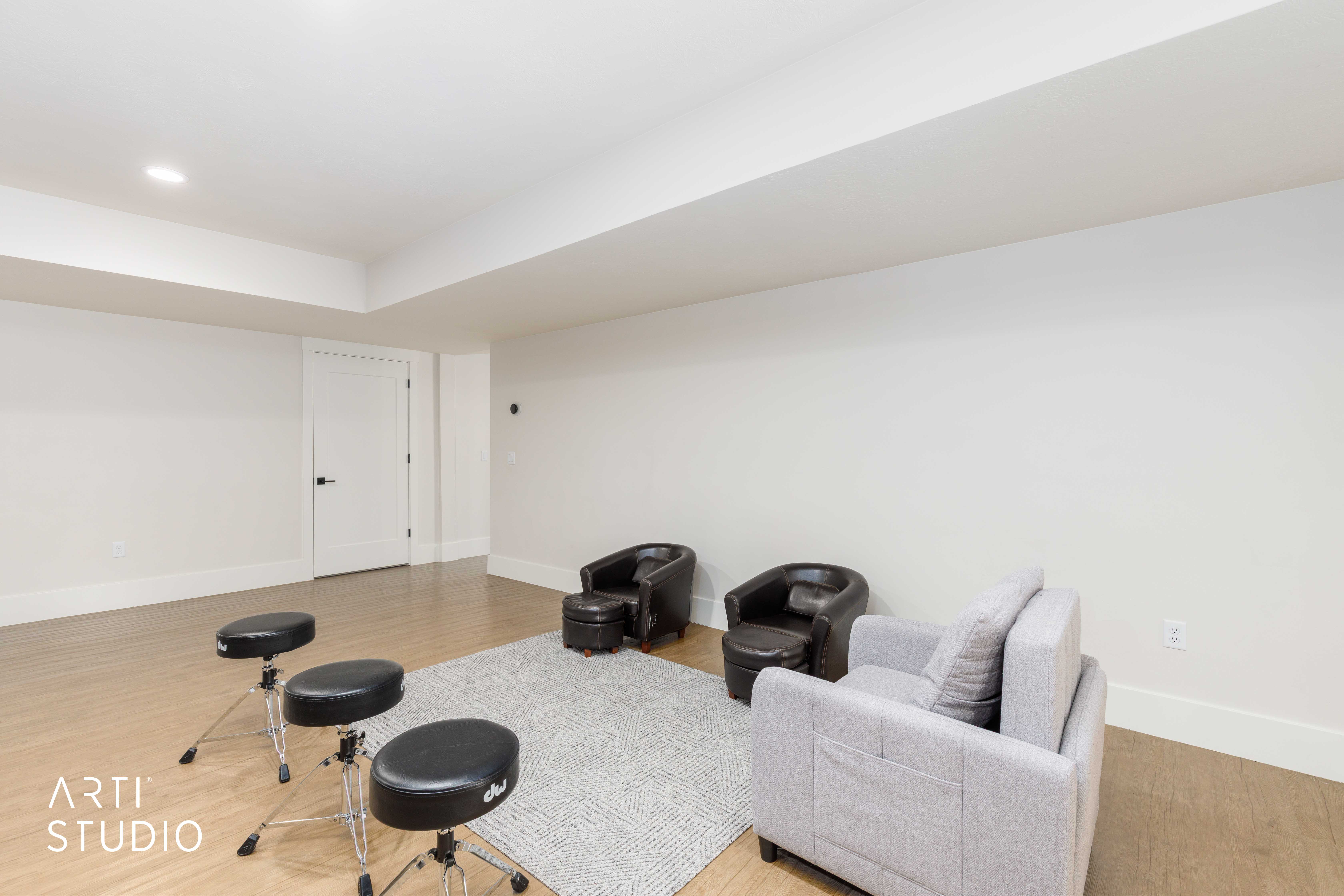 Spacious room featuring light wood-finish flooring, recessed lighting, white walls, and bright white trim