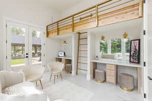 Interior space with a wood-finish loft featuring a gold-toned railing and ladder, dual vanity stations with integrated mirrors and wall sconces, and white tile flooring