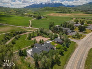 Expansive property with multiple buildings, mature trees, and a paved driveway