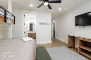 Bright room featuring a ceiling fan with integrated lighting, wood-finish flooring, and recessed lighting