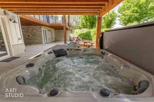 Outdoor hot tub with integrated lighting, set on a concrete patio