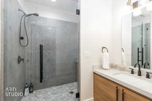 Contemporary bathroom featuring a spacious glass-enclosed shower with large format wall tiling and hexagonal floor tiling