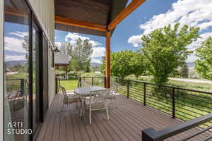 Covered outdoor deck featuring composite decking and black horizontal railing