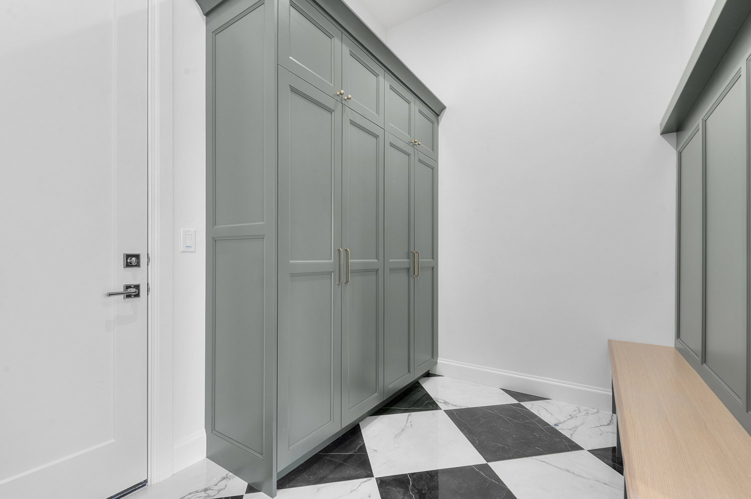 Entryway with tall built-in cabinetry and a wood-finish bench