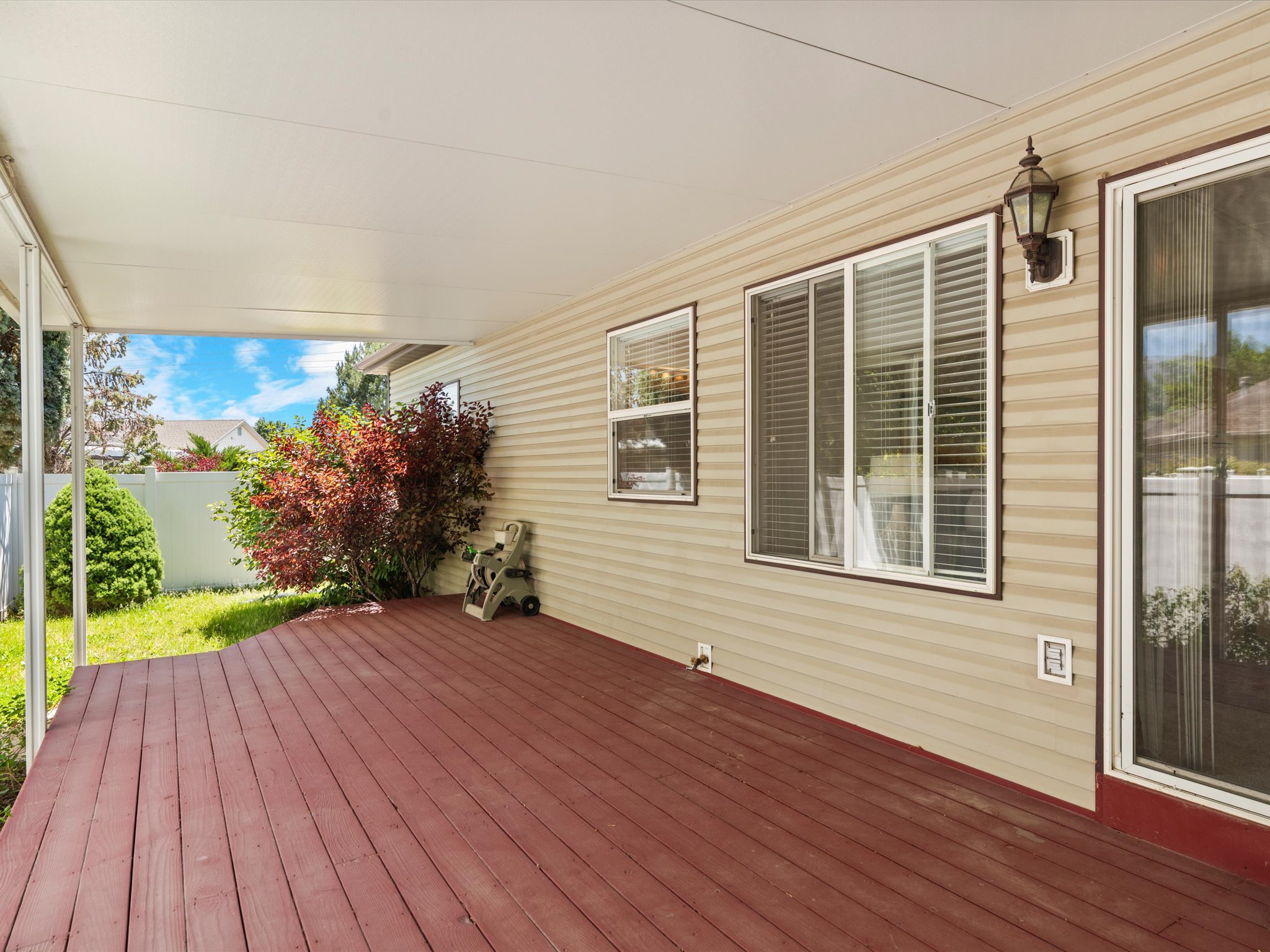 Expansive covered patio featuring a rich wood-finish deck