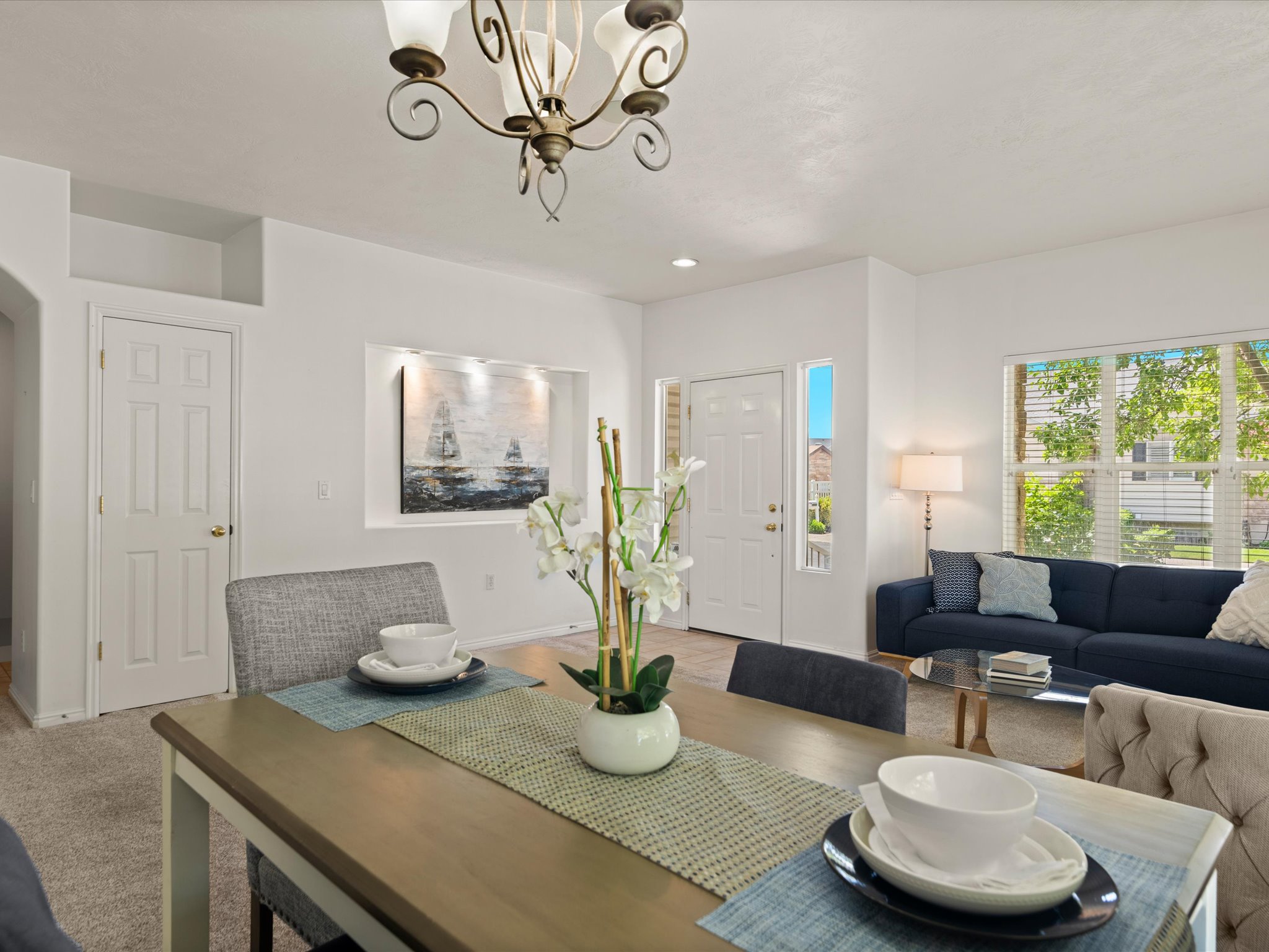 Open-concept dining area featuring a decorative chandelier