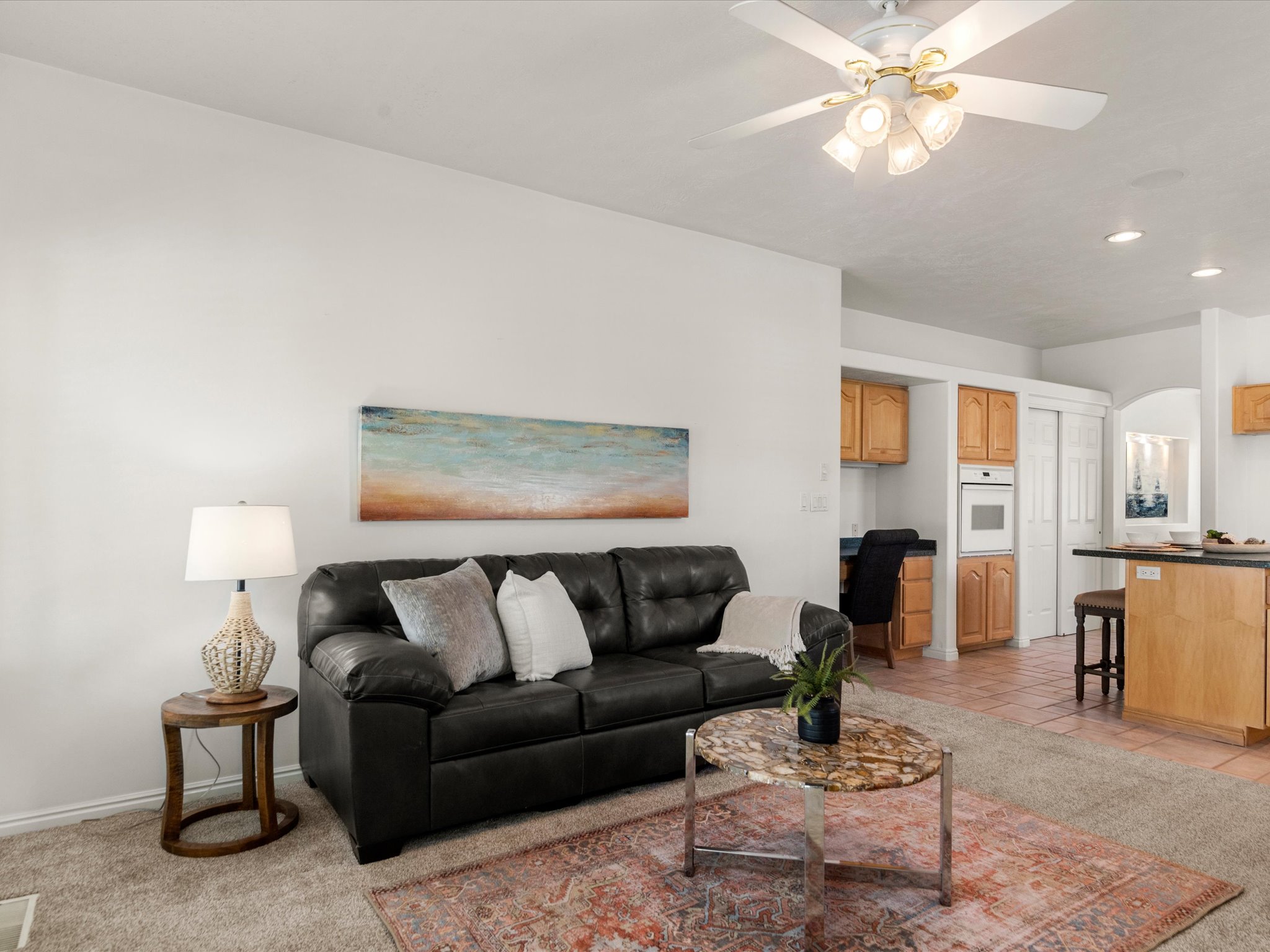 Open-concept living area featuring a ceiling fan with integrated lighting, recessed lighting, and light-toned walls