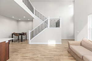 Expansive interior featuring an open-concept layout with light wood-finish flooring