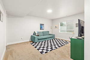Carpeted room with light-toned walls and a single window with blinds