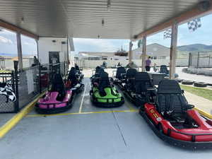 Covered go-kart staging area featuring multiple vehicles