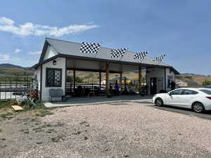 Commercial structure with a gray metal roof, white siding, and dark trim accents
