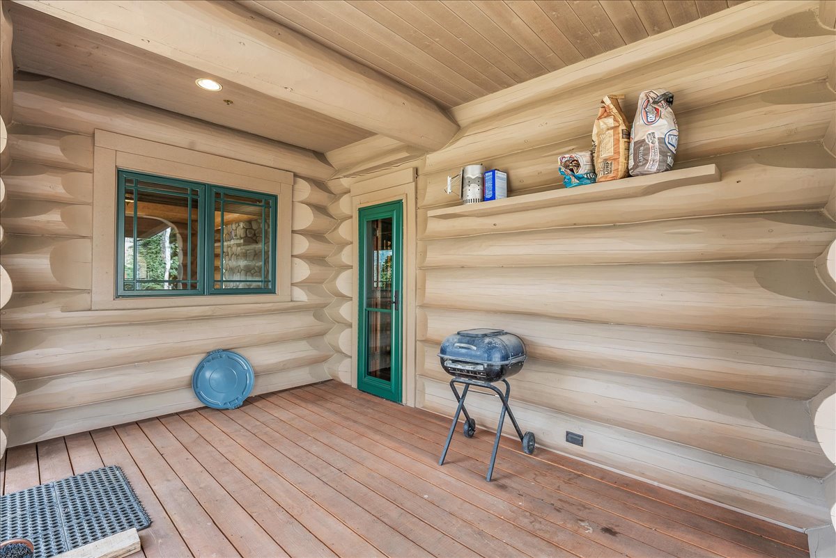 Expansive wood-finish deck with log construction walls and ceiling