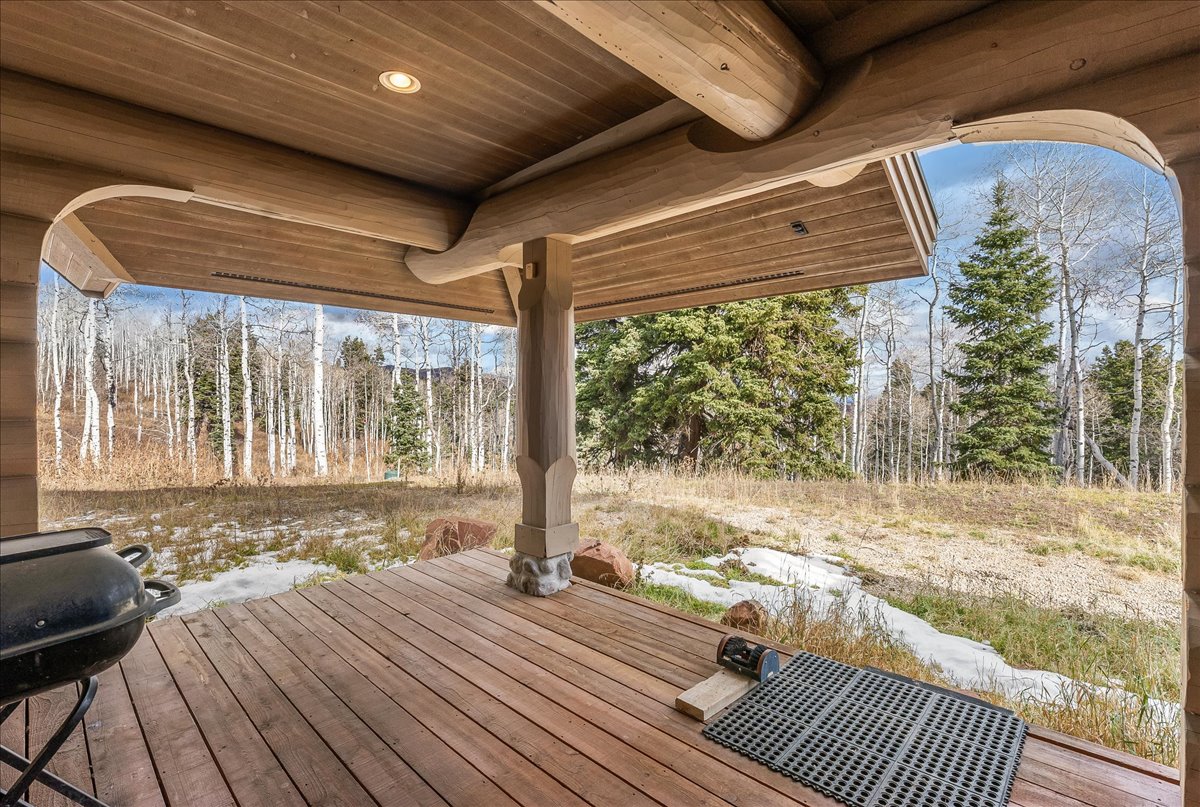 Expansive wood-plank deck featuring a wood post and beam support structure