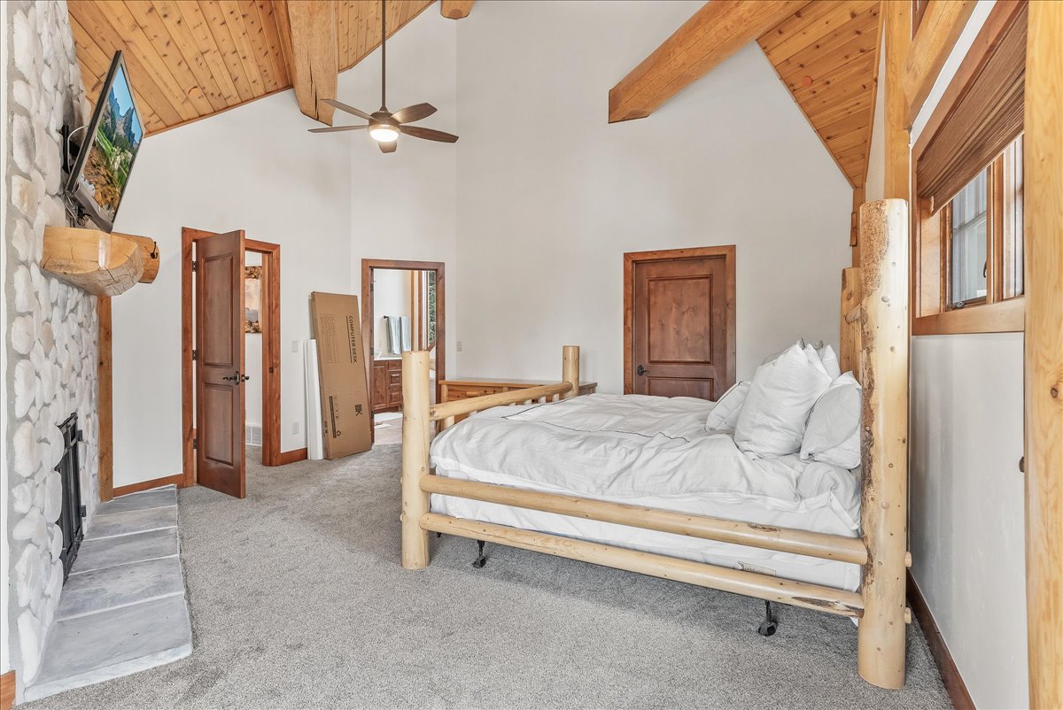 Vaulted tongue-and-groove wood plank ceiling with exposed wood beams
