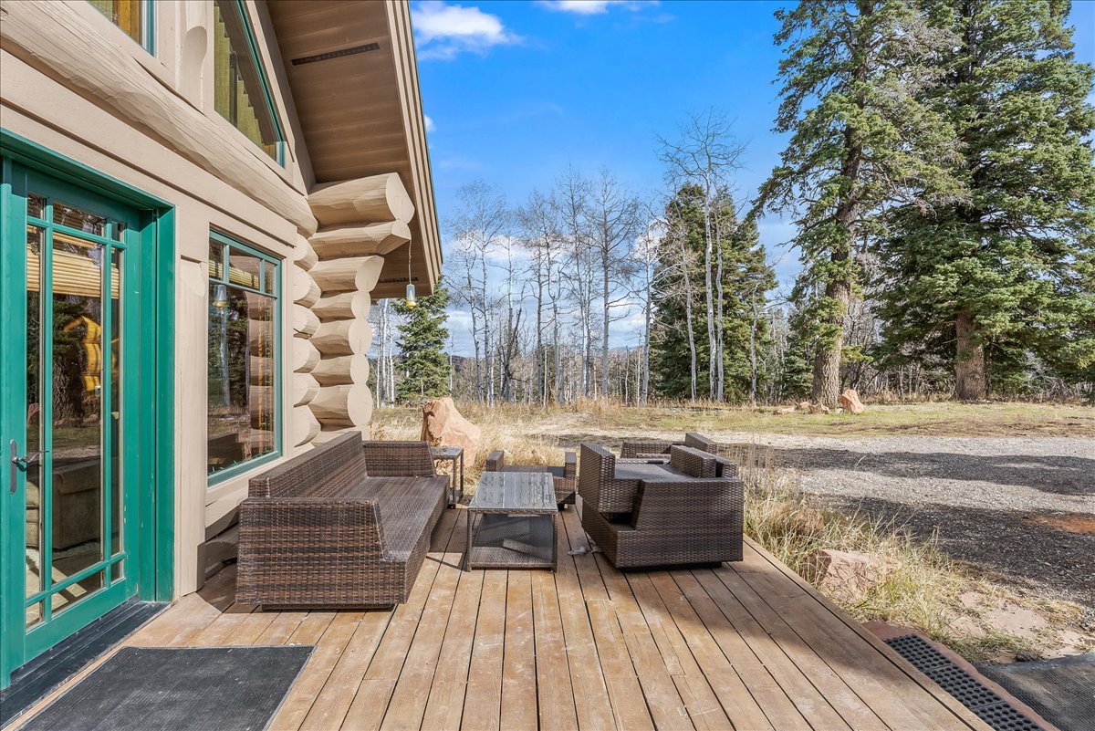 Expansive outdoor deck featuring wood flooring and a log cabin exterior