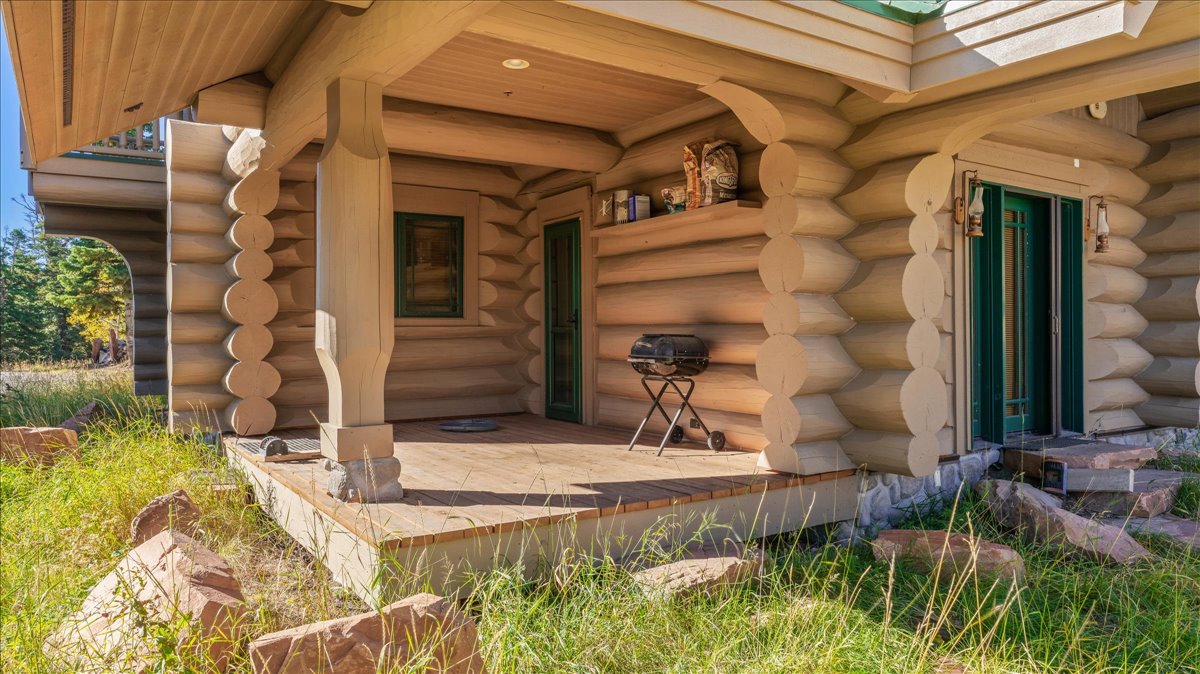Wood-finish exterior featuring a covered porch with decorative columns