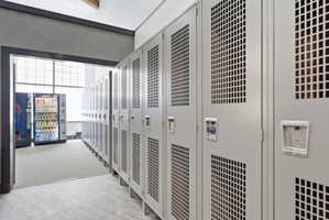 Row of light gray metal lockers with perforated panels