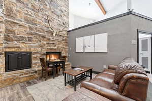 Stone-faced fireplace with a hearth and a secondary storage unit