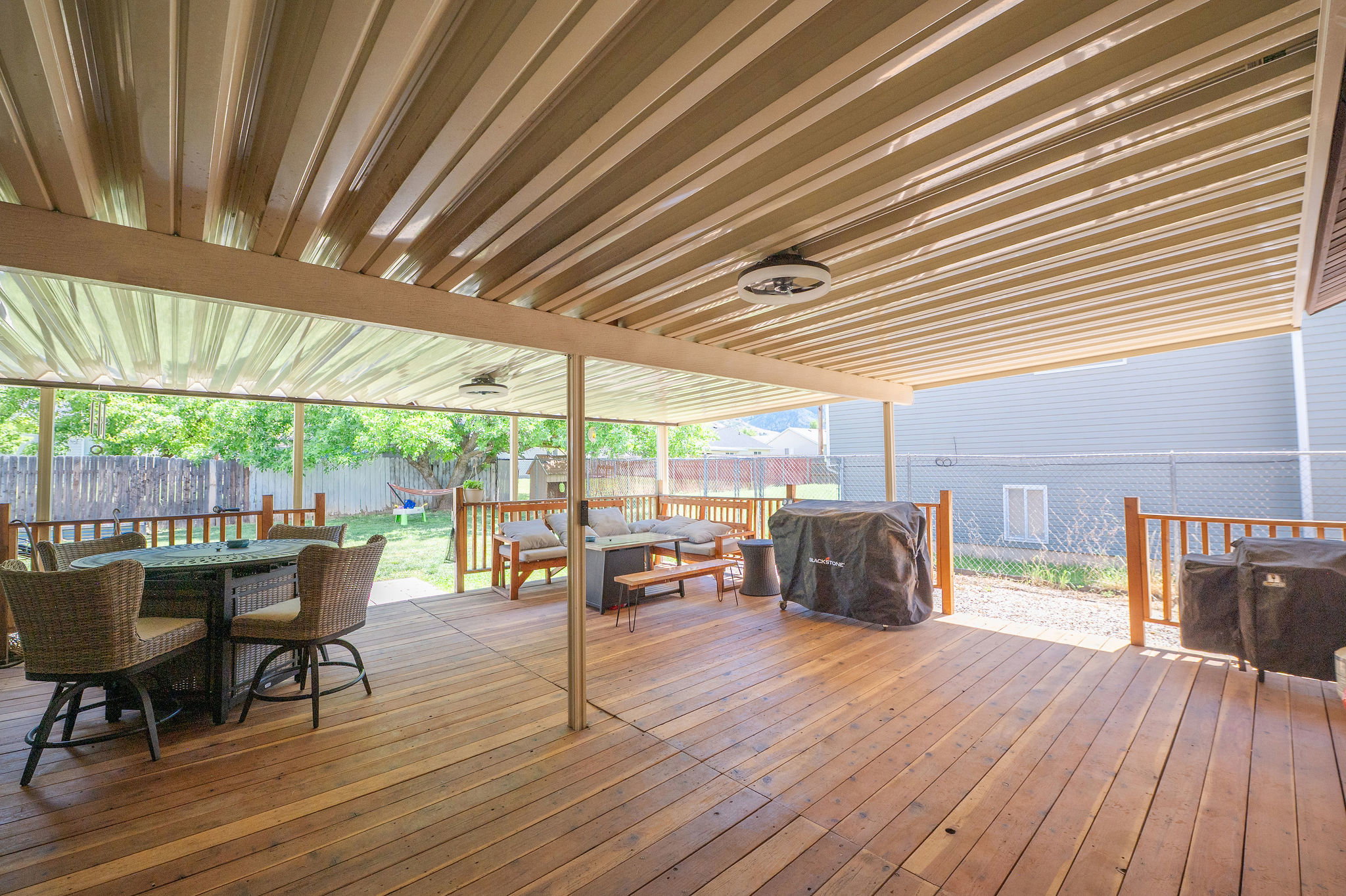 Expansive covered wooden deck perfect for shade during the summer days, rainy nights, and entertaining!