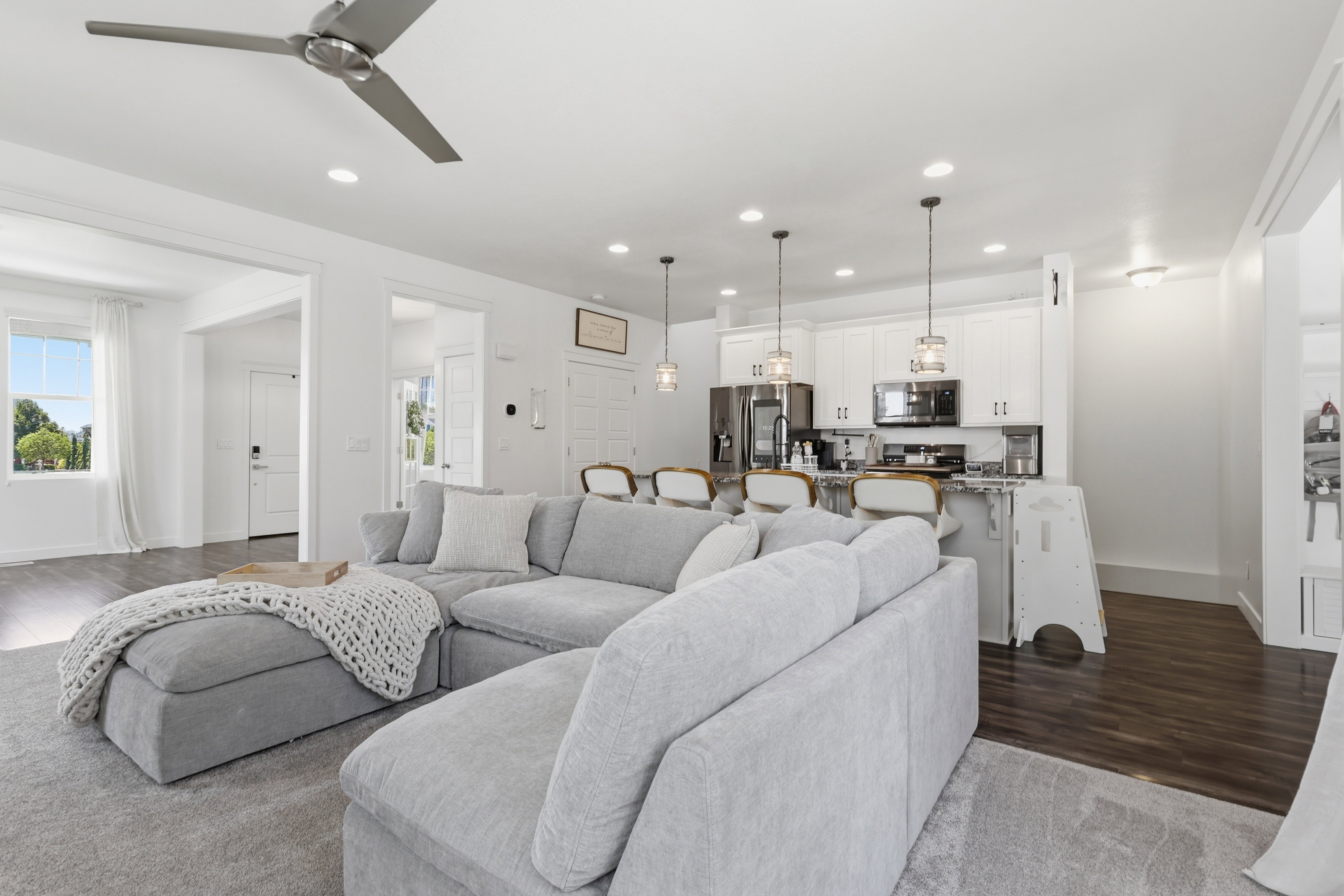 Open-concept living space featuring recessed lighting, a ceiling fan, and hardwood flooring