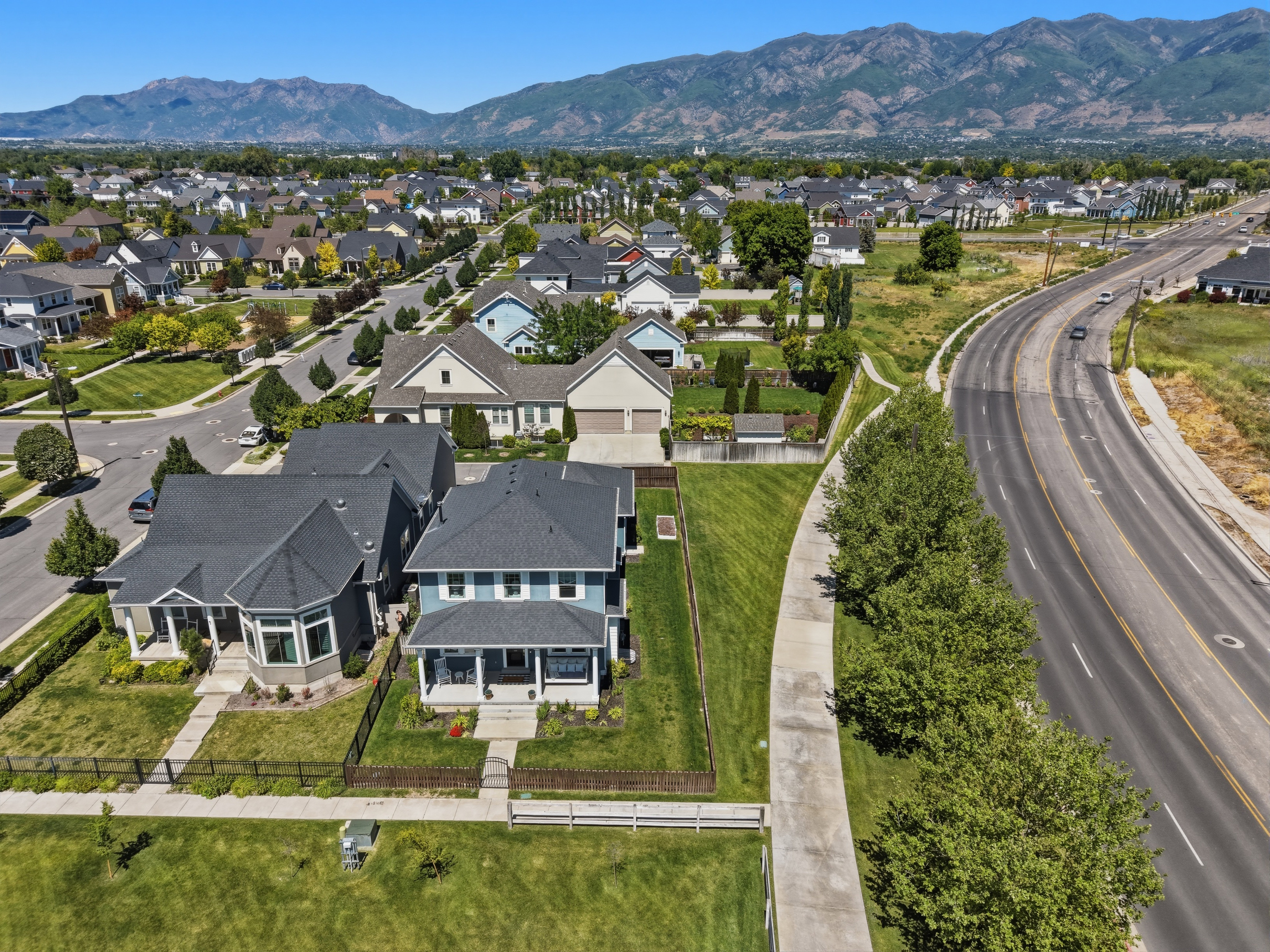 Aerial perspective showcasing a residential community with distant mountain ranges