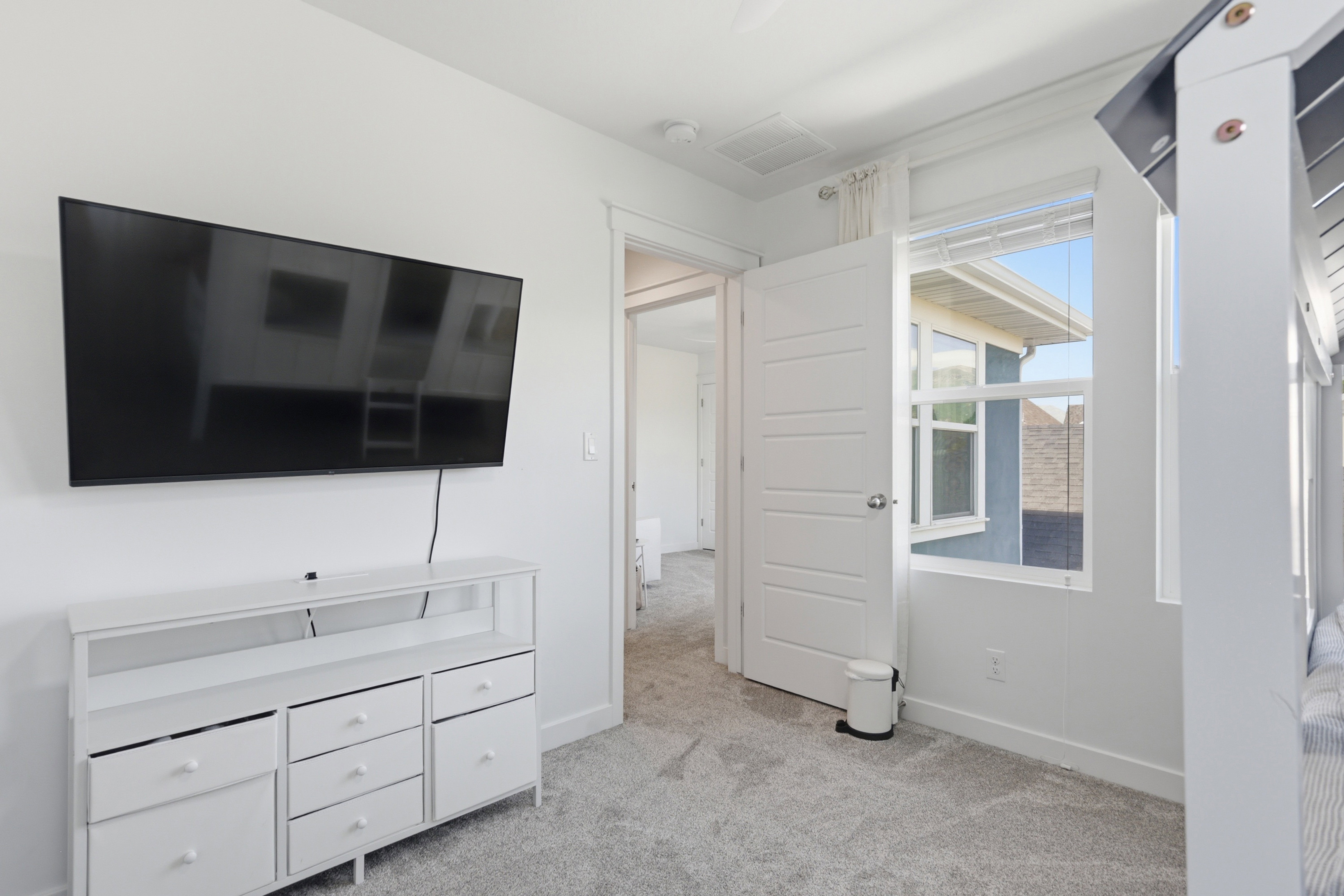 White interior walls with light gray carpet flooring