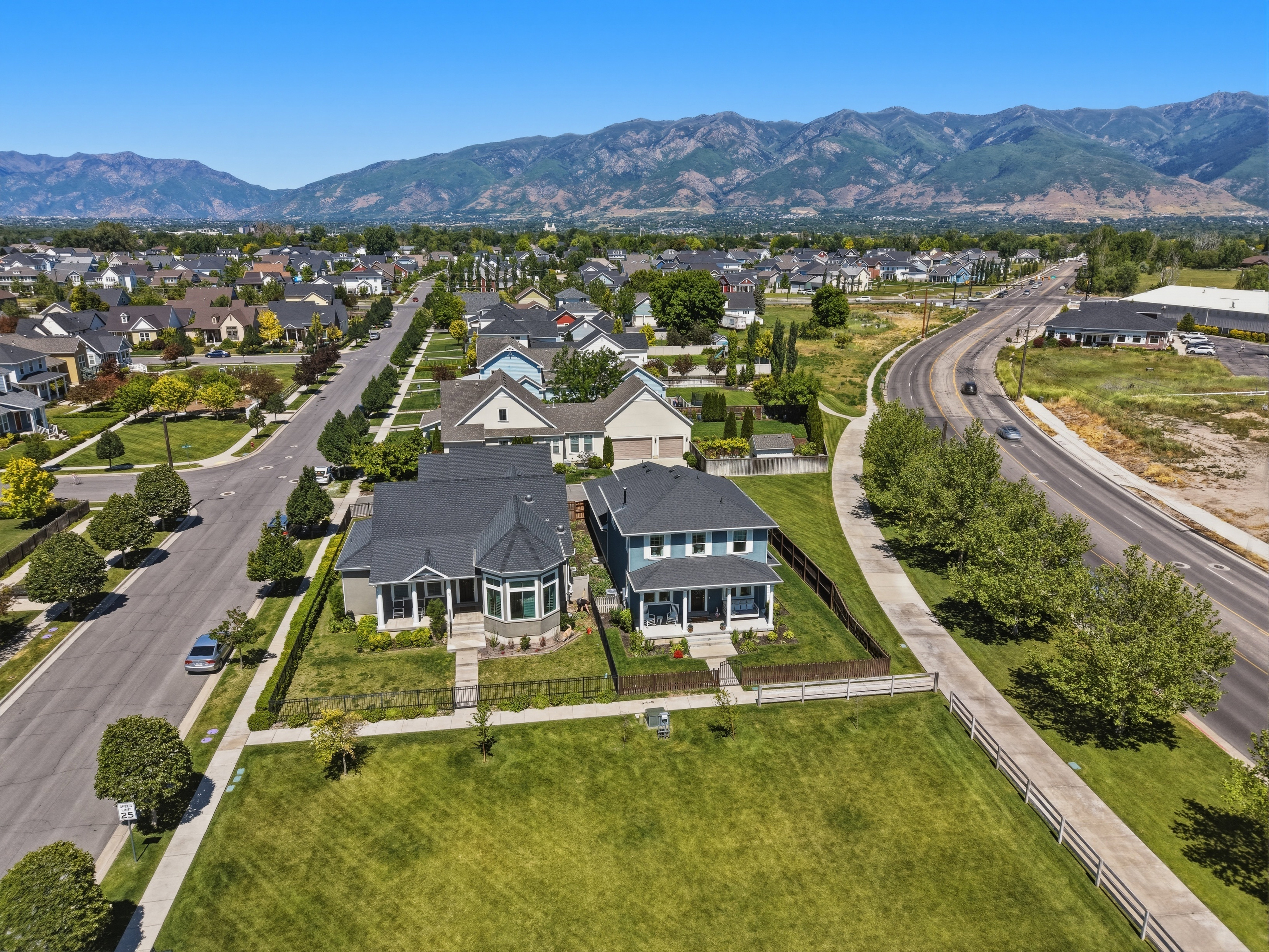 Expansive neighborhood showcasing a variety of architectural styles, tree-lined streets, and mountain backdrop