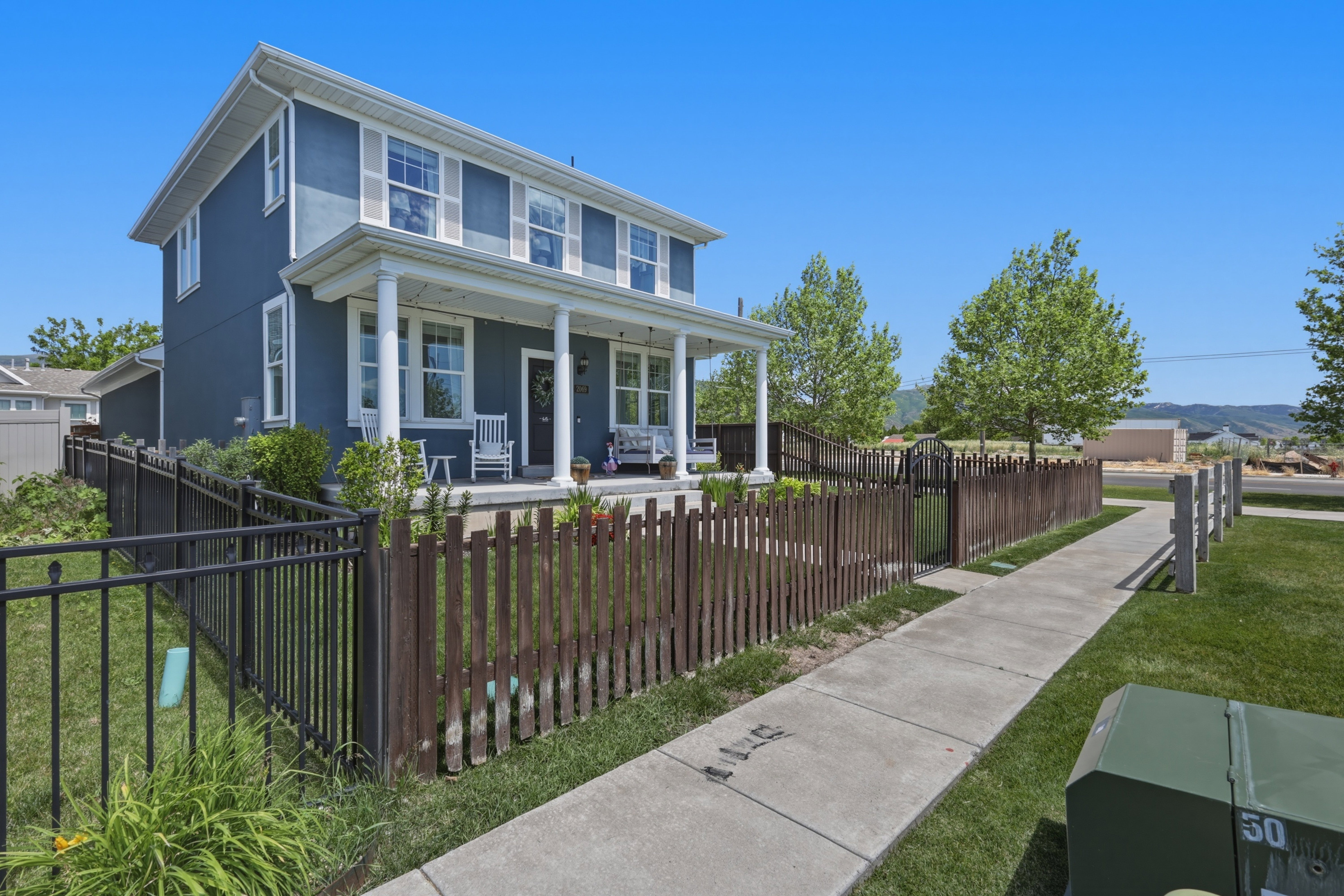 Two-story exterior with blue siding and white trim