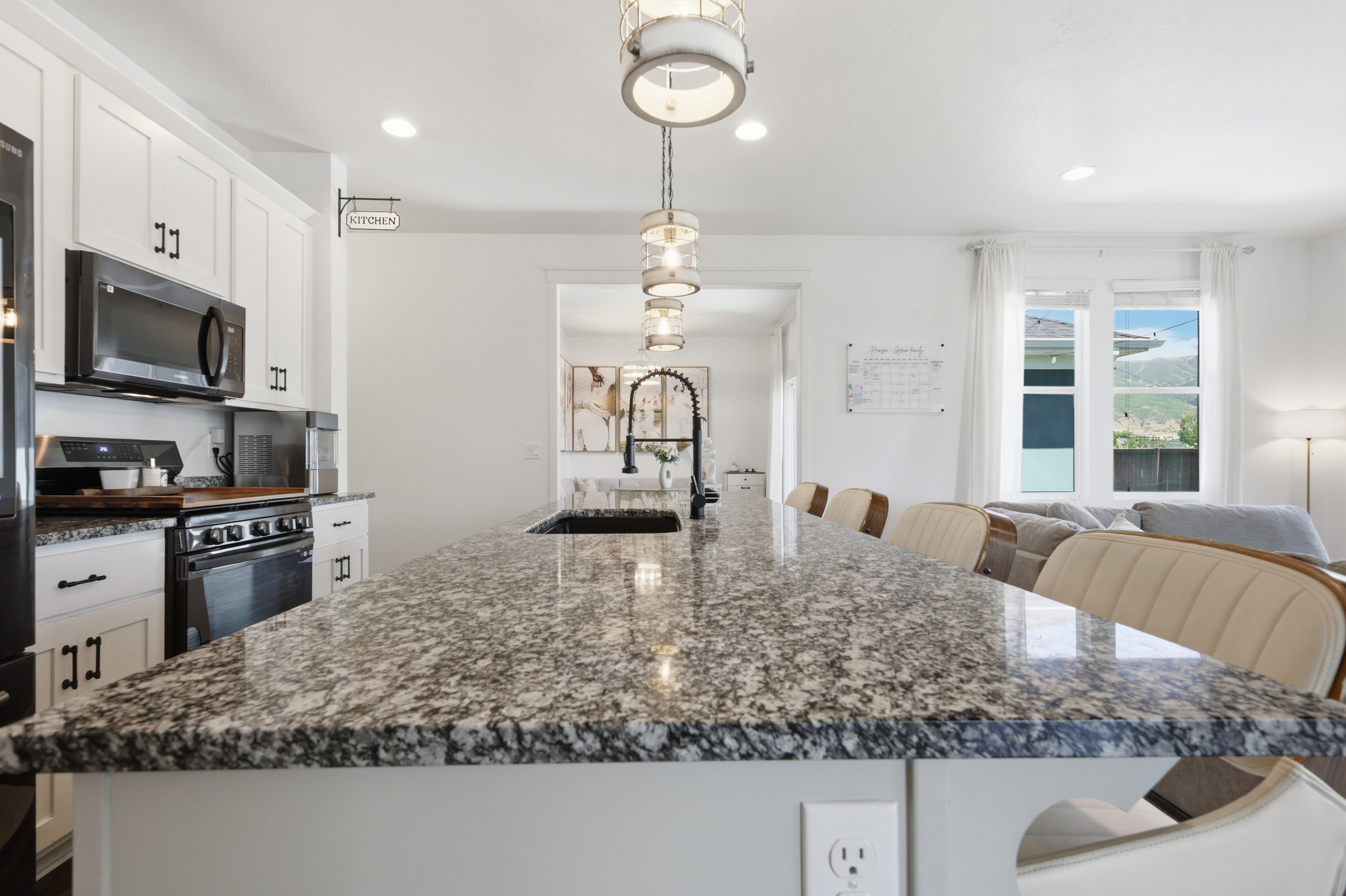 Expansive island with a speckled countertop and integrated sink