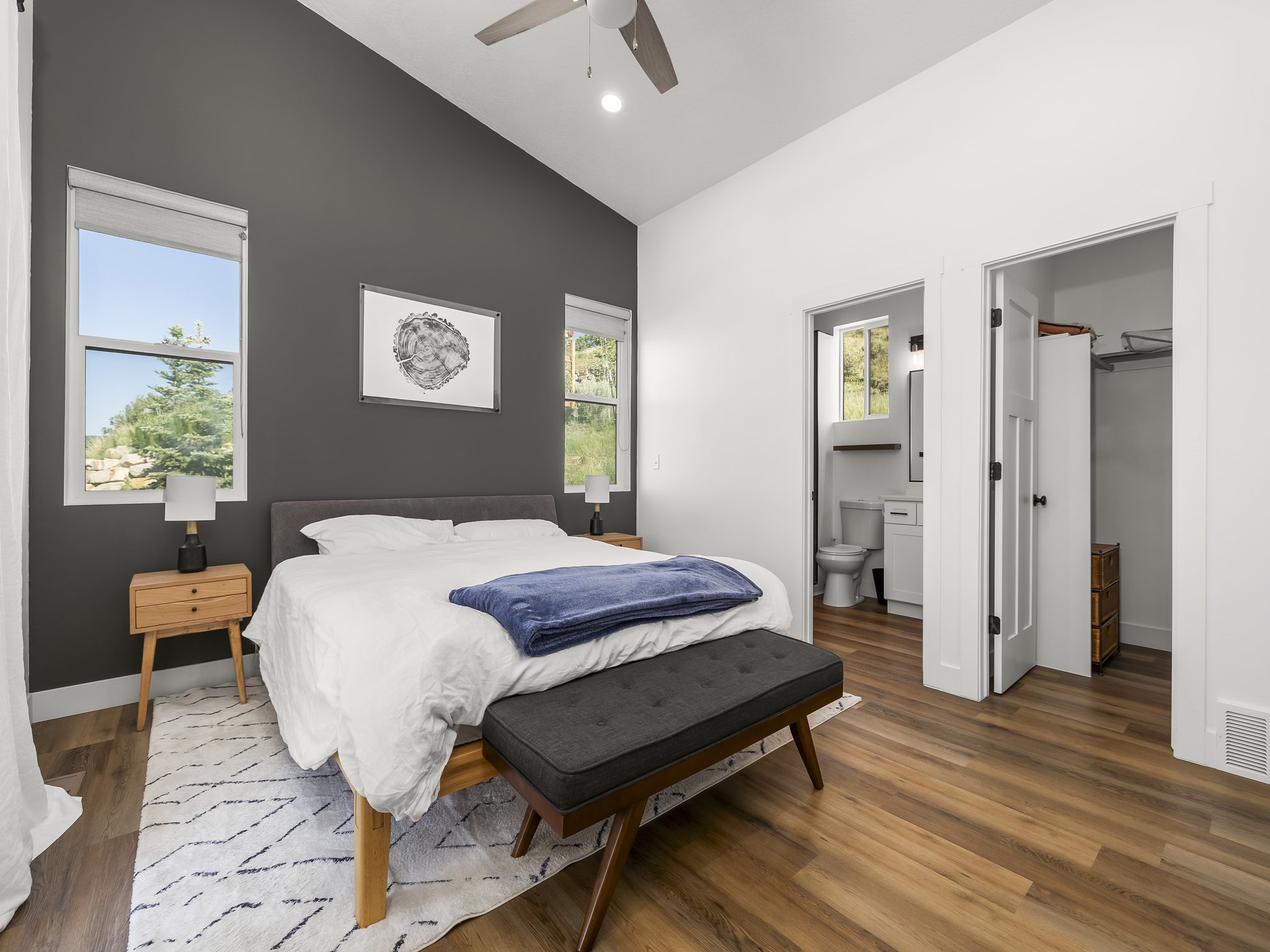 Vaulted ceilings accentuate the room's height, complemented by contemporary wood-finish flooring