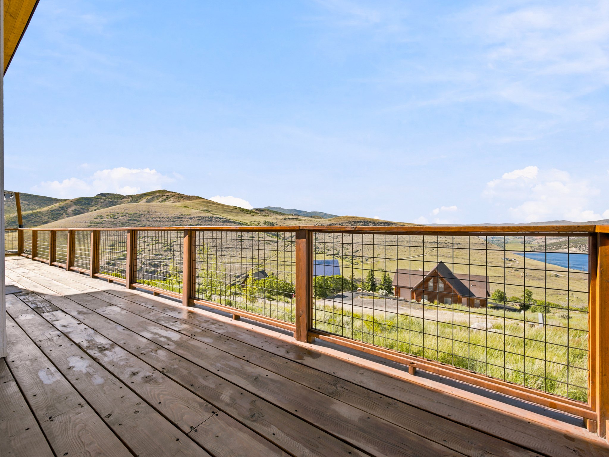 Expansive wood deck with metal grid railing