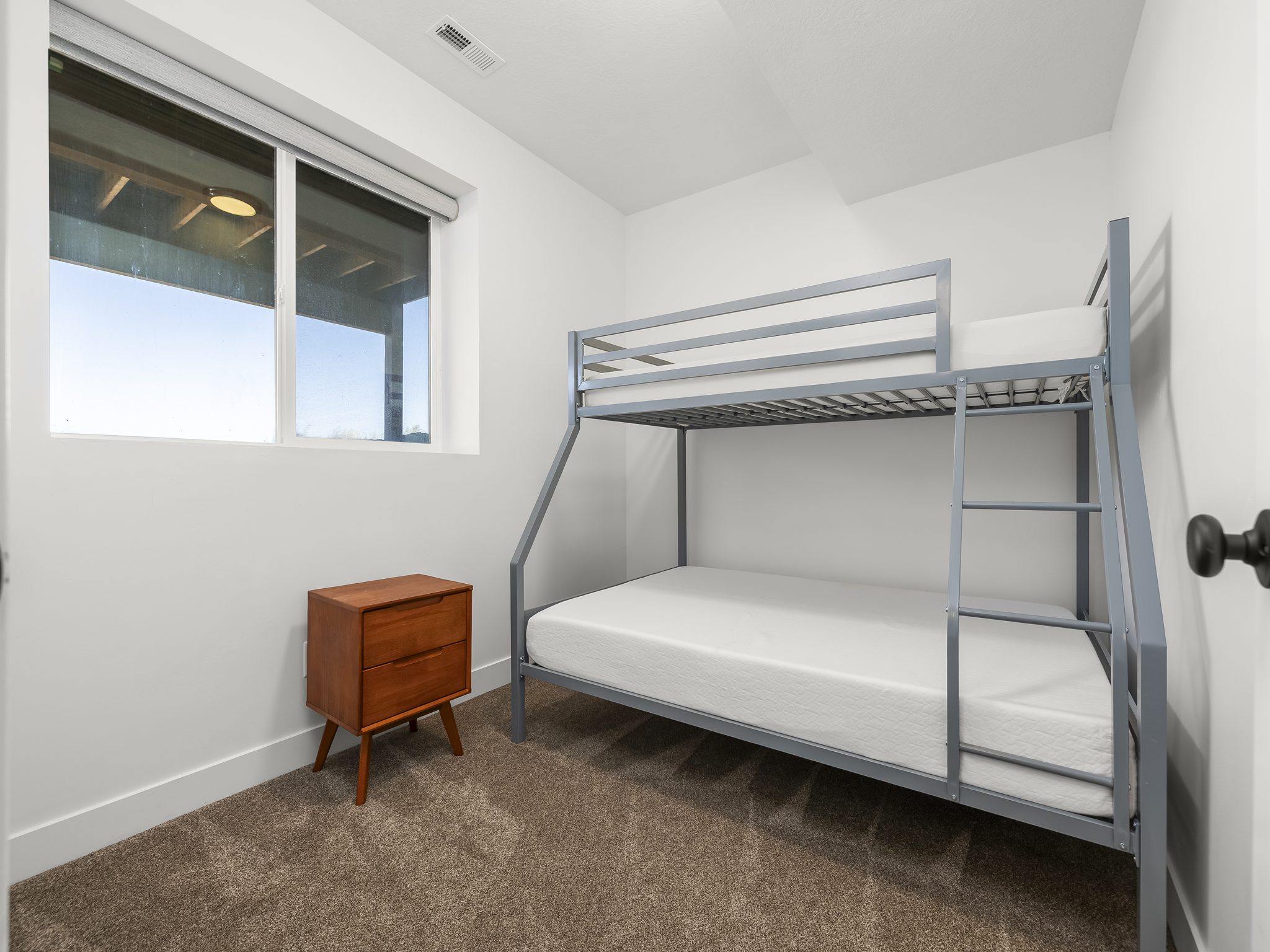 Bright room featuring a large window with roller shades