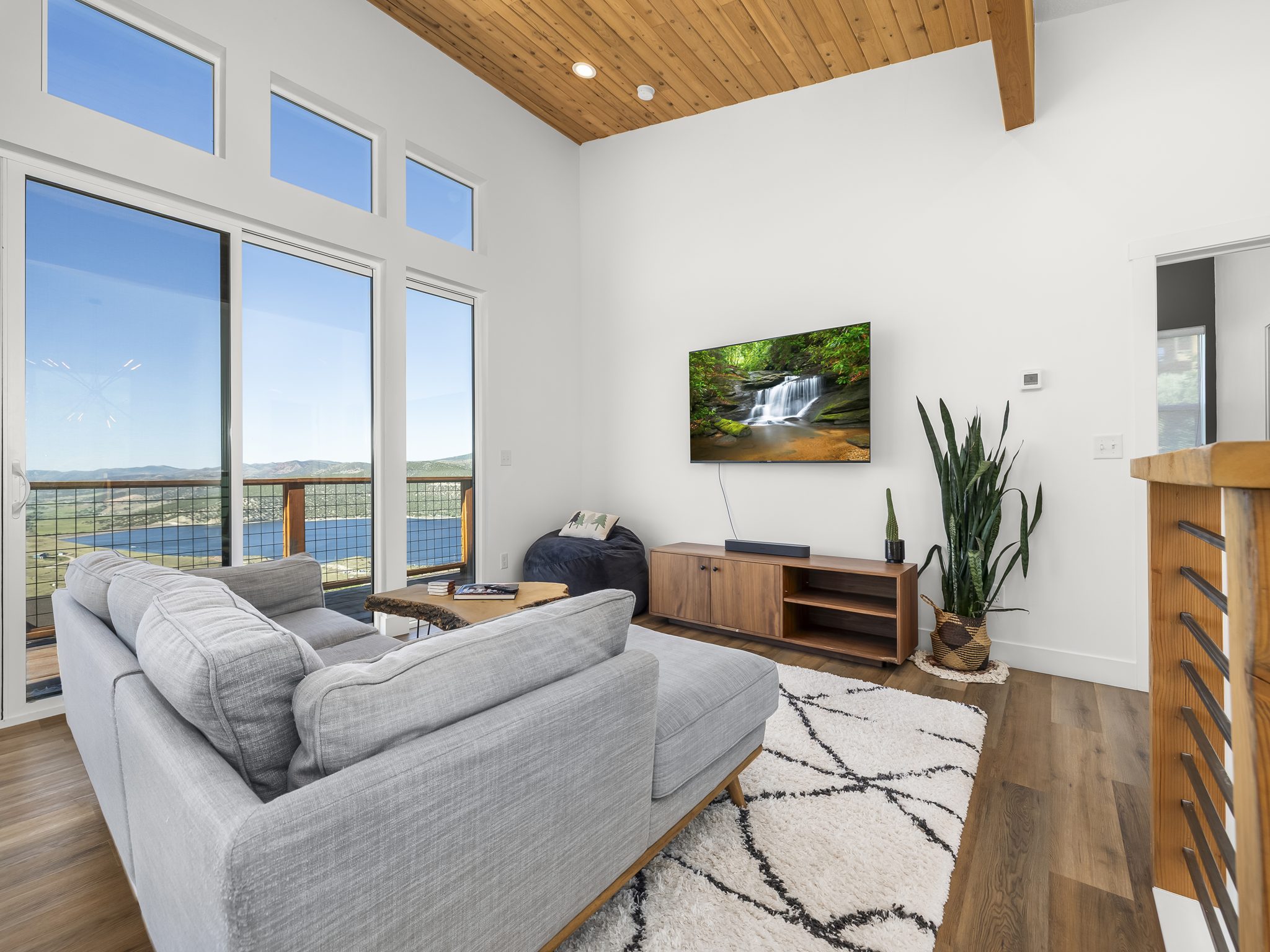 Vaulted ceiling featuring natural wood planks and exposed beam