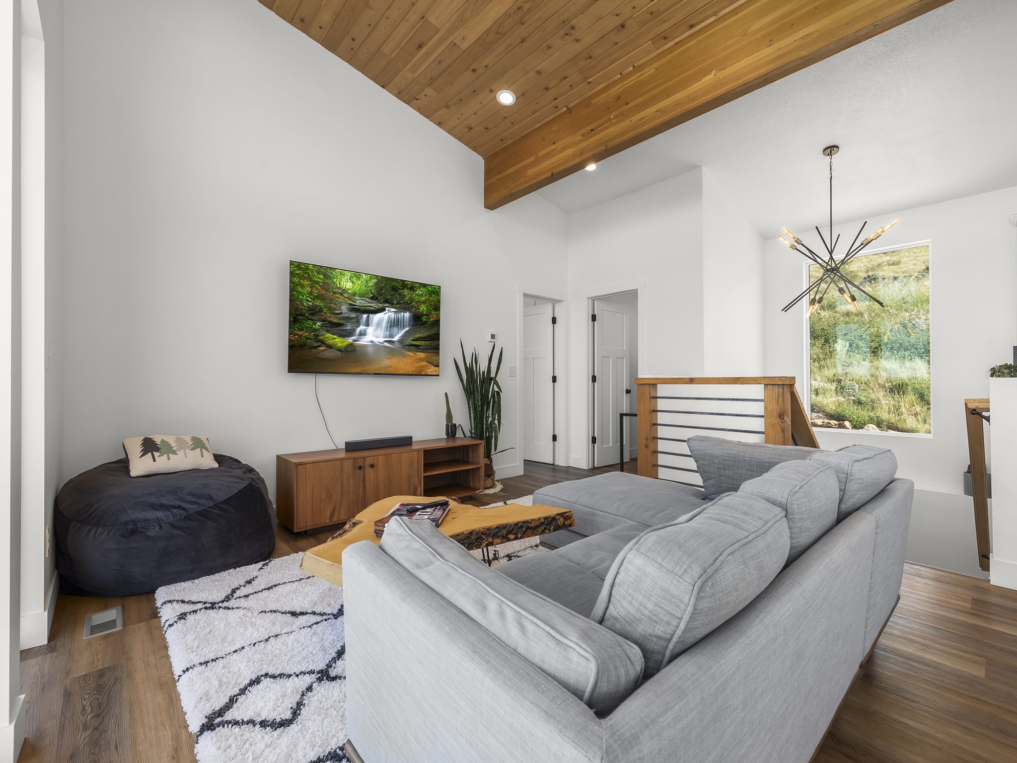 Living area featuring a vaulted wood-finish ceiling, recessed lighting, and wood-finish flooring