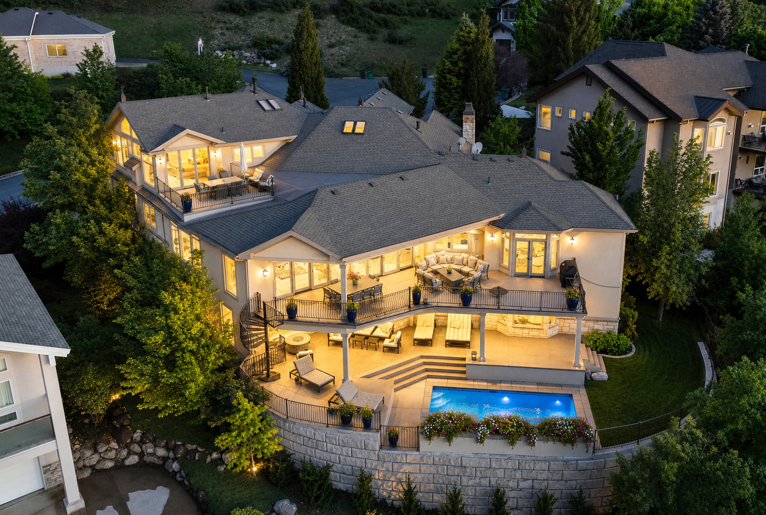 Multi-level stucco exterior featuring expansive balconies, a built-in swimming pool, spiral staircase, and terraced landscaping