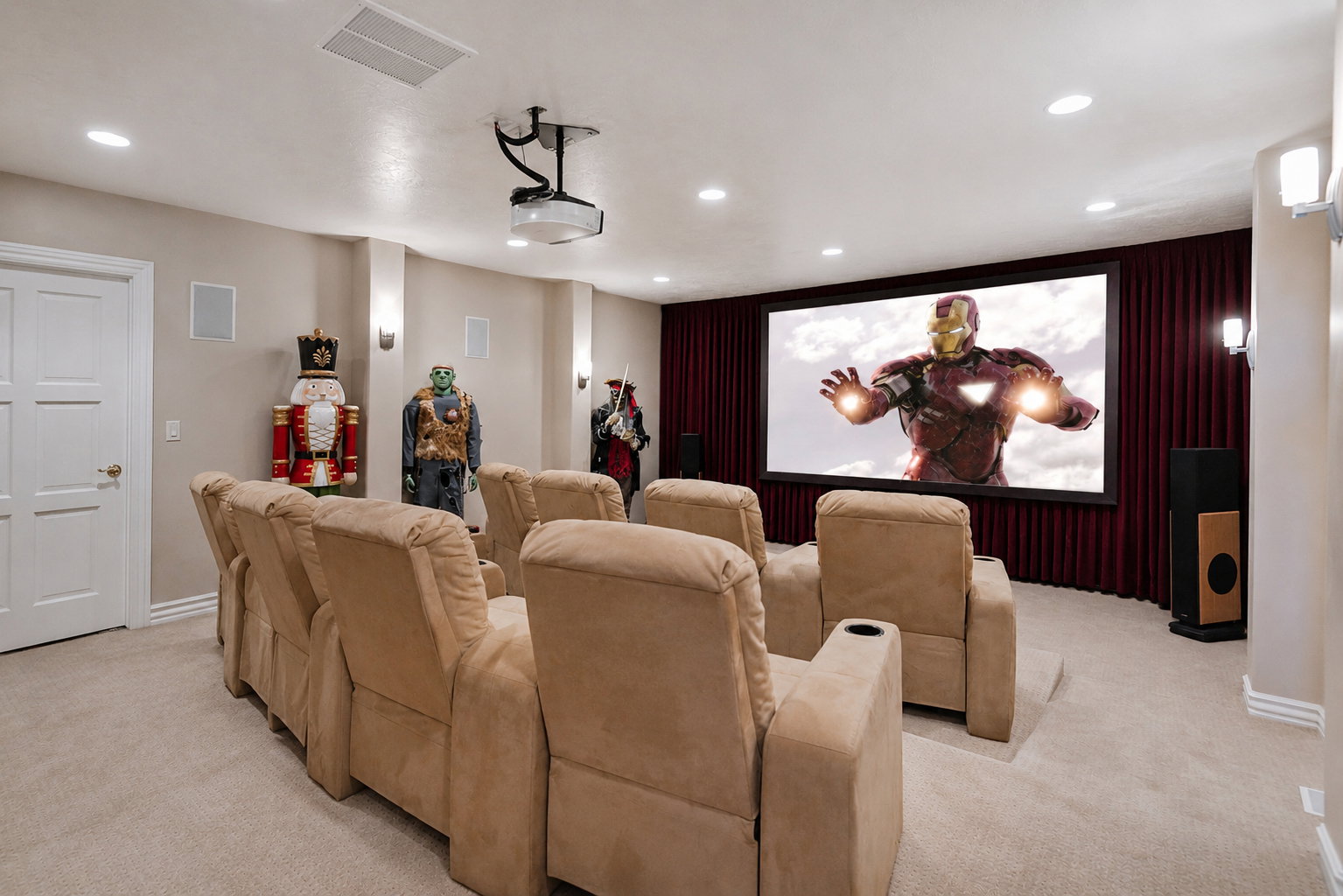 Dedicated home theater featuring a large projection screen, recessed lighting, and wall-mounted sconces