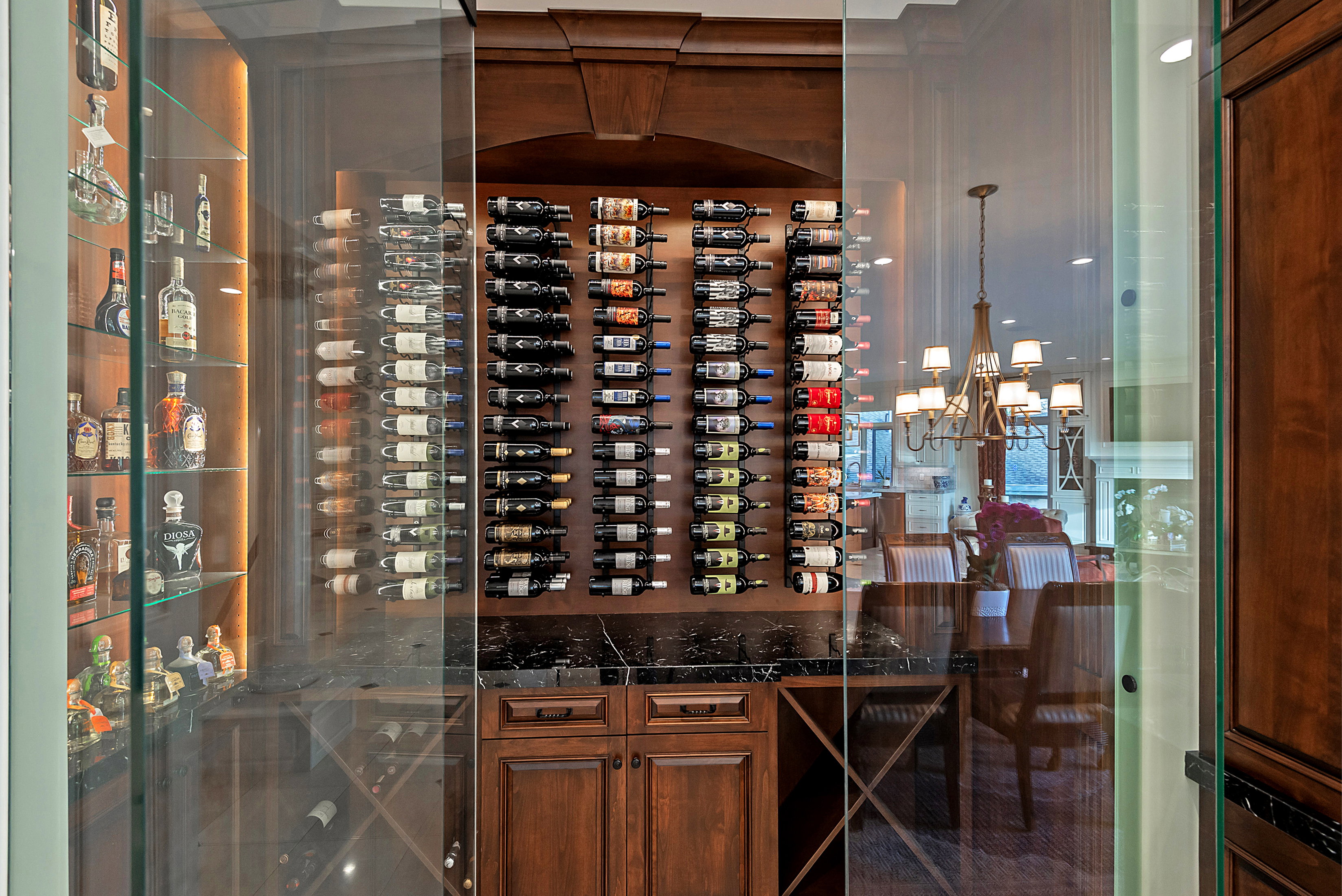Custom wine storage system featuring glass enclosure and dark wood cabinetry
