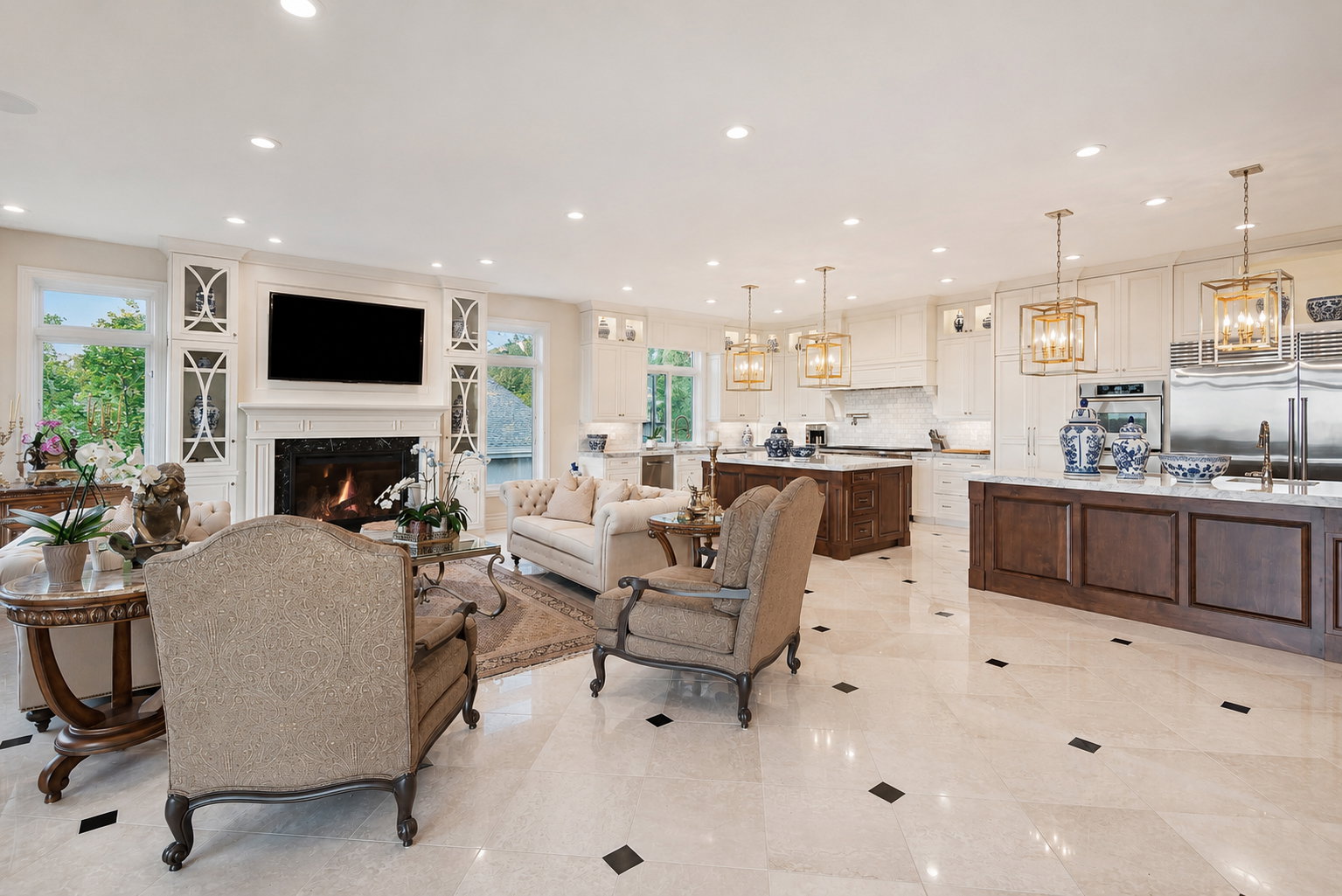 Expansive living area with a fireplace and built-in cabinetry, featuring light-toned flooring with dark accent tiles