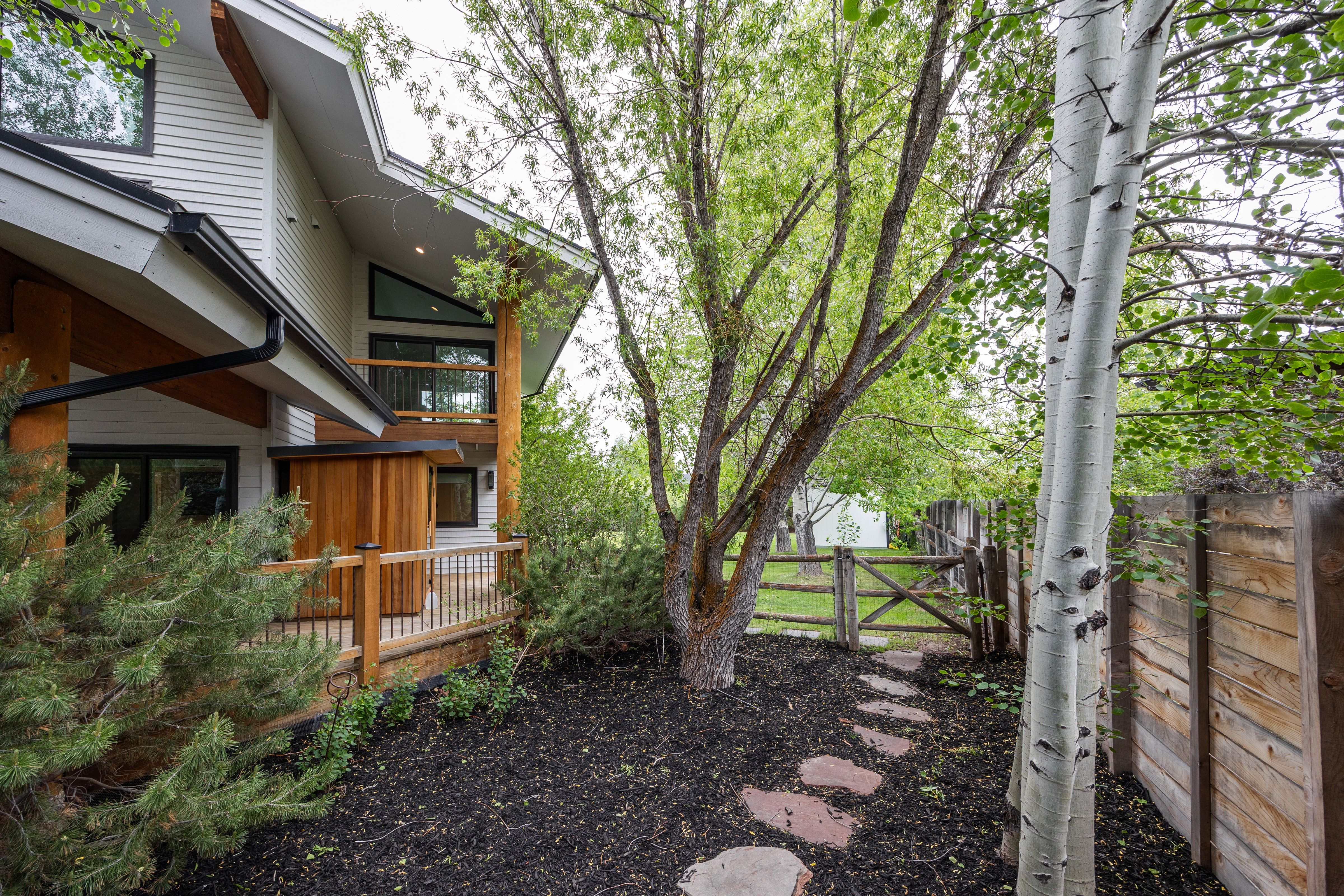 Multi-level exterior featuring white siding and black trim