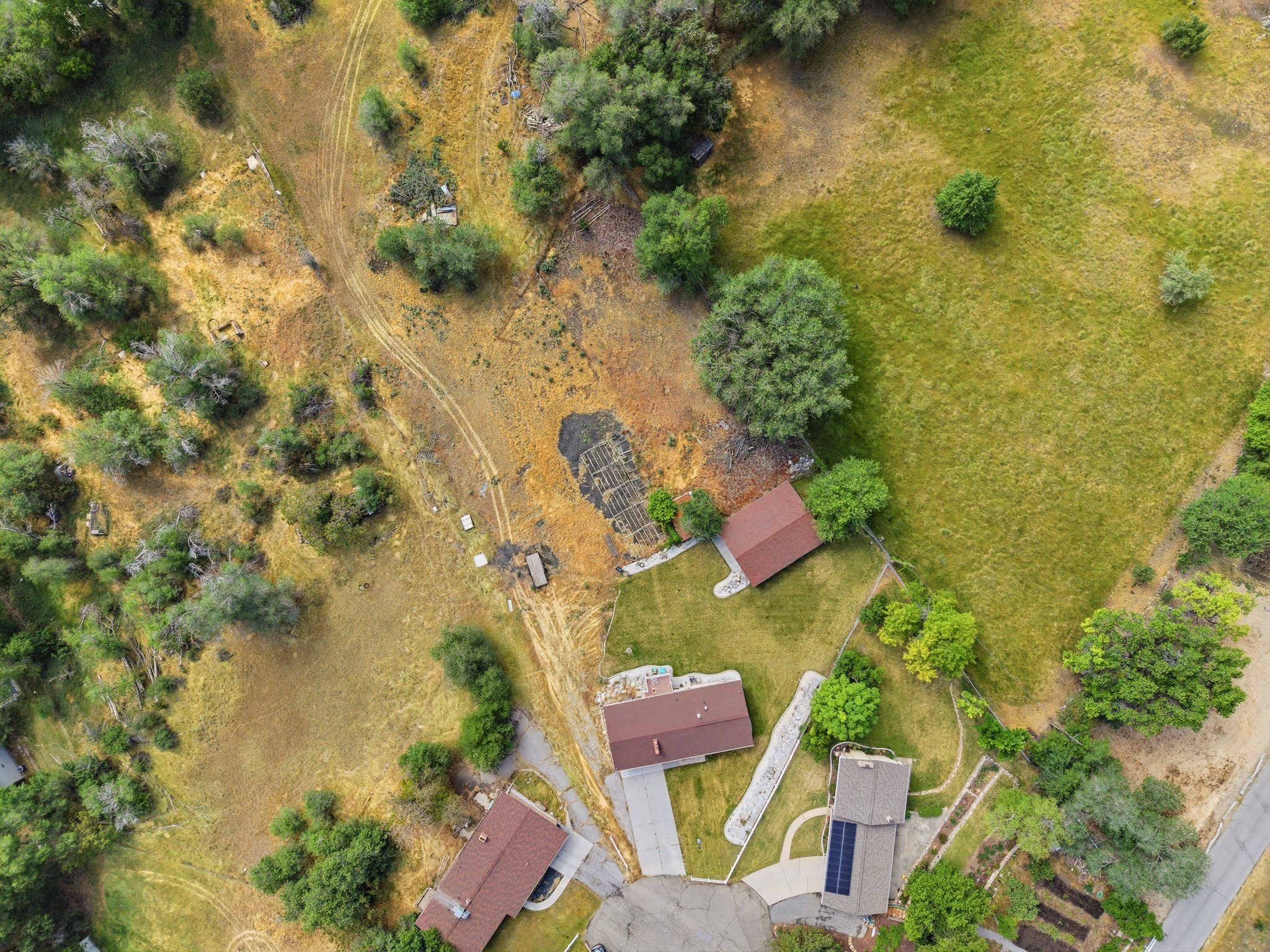 Aerial perspective showcasing multiple properties and expansive natural landscaping