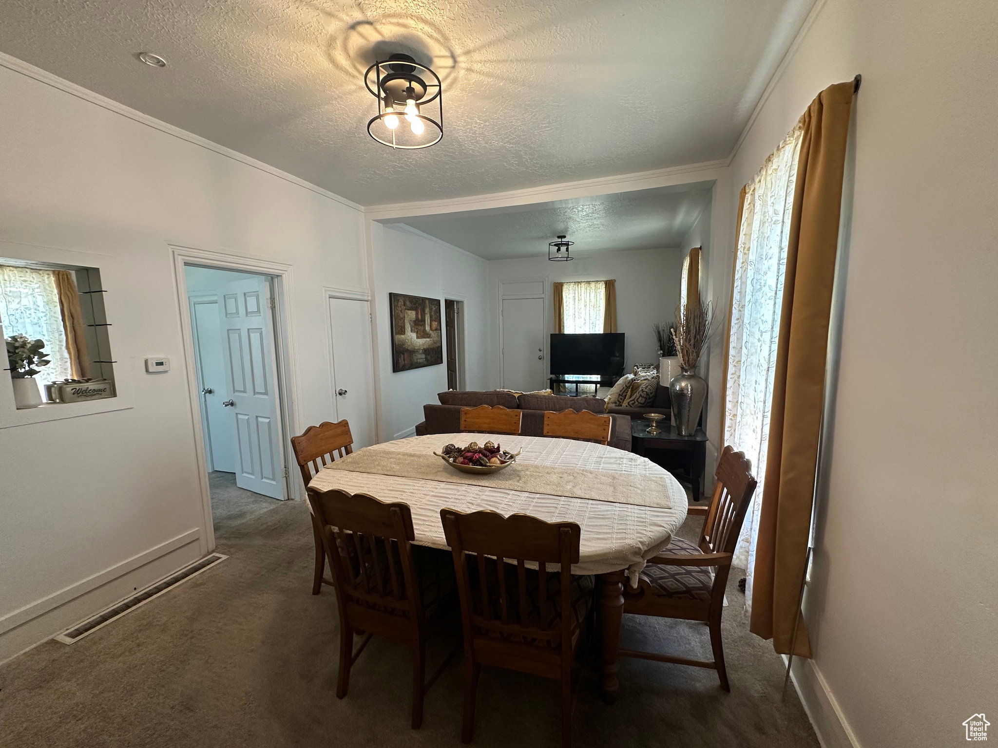 Dining space featuring carpet flooring and a contemporary overhead light fixture