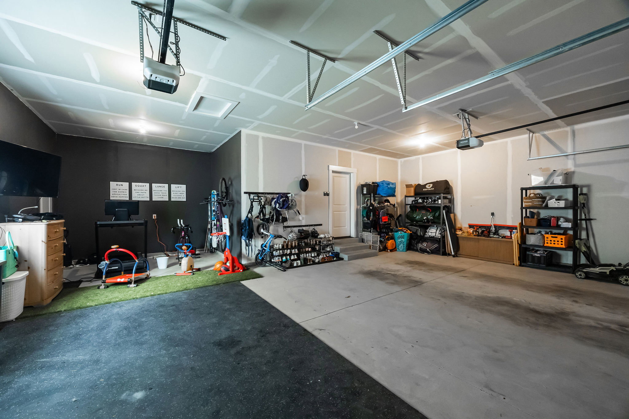 Spacious garage featuring concrete flooring and a painted accent wall