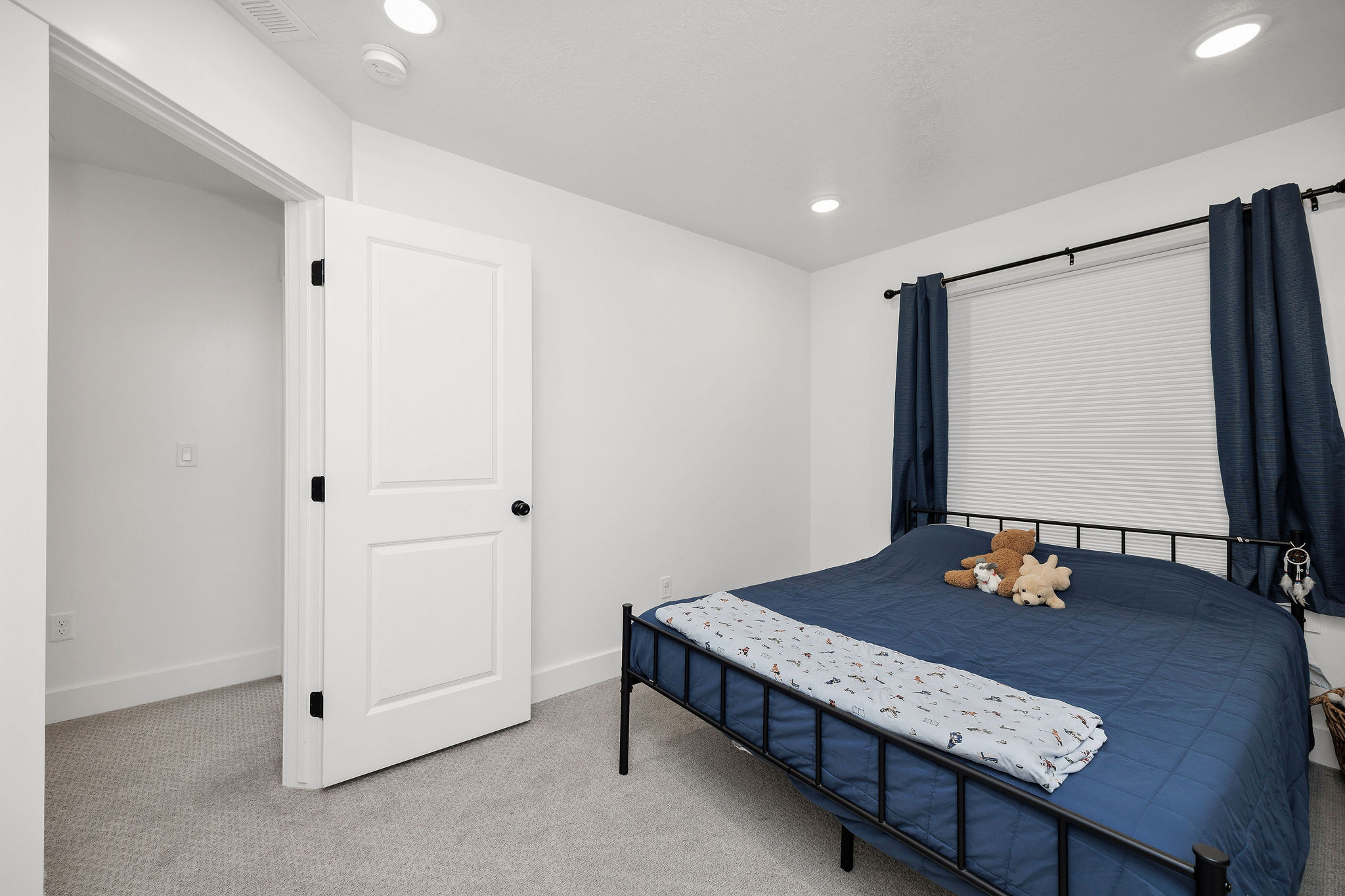 Bedroom featuring recessed lighting, a window with blinds, and light gray carpet