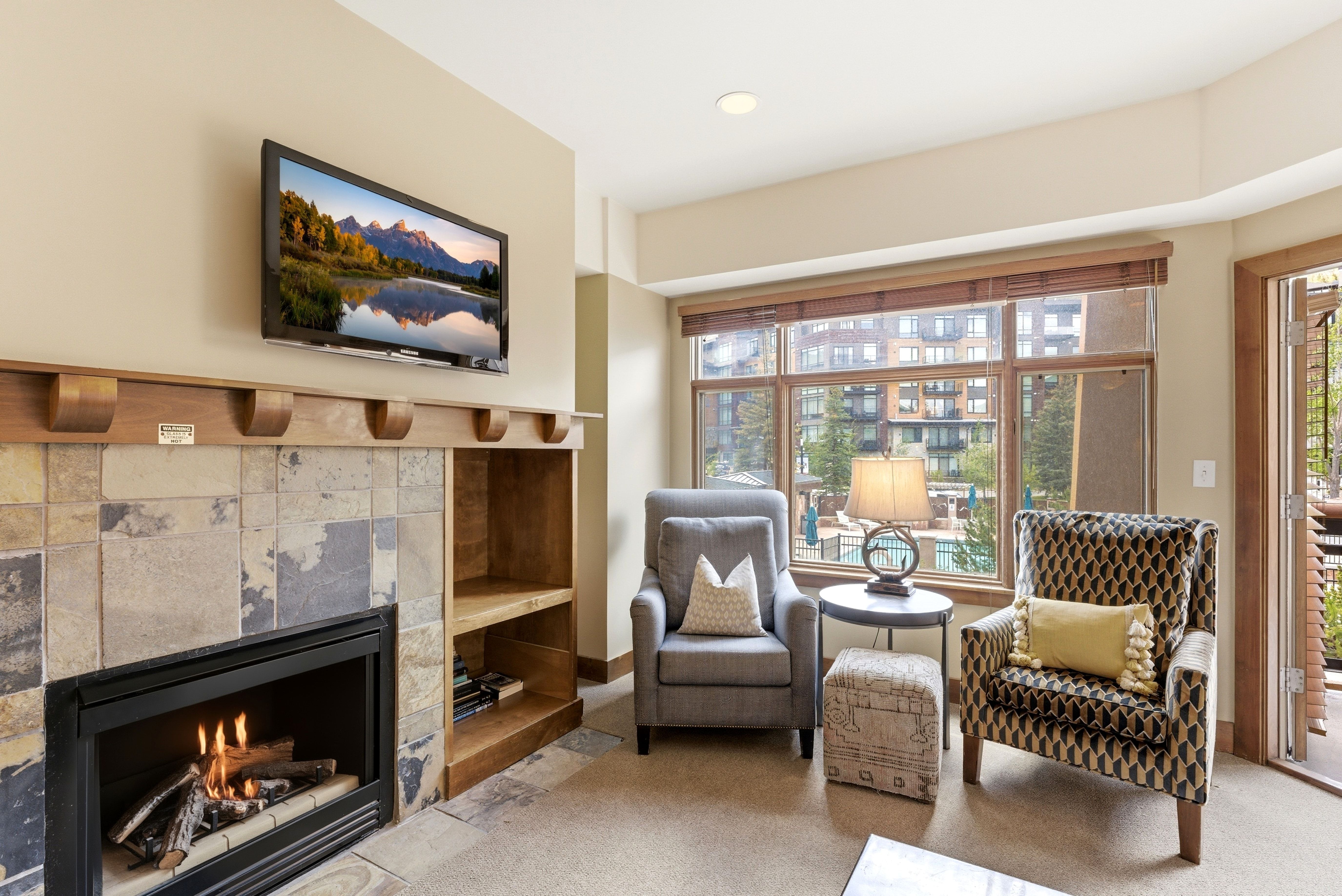 Tile-surround fireplace with a wood mantle and built-in shelving