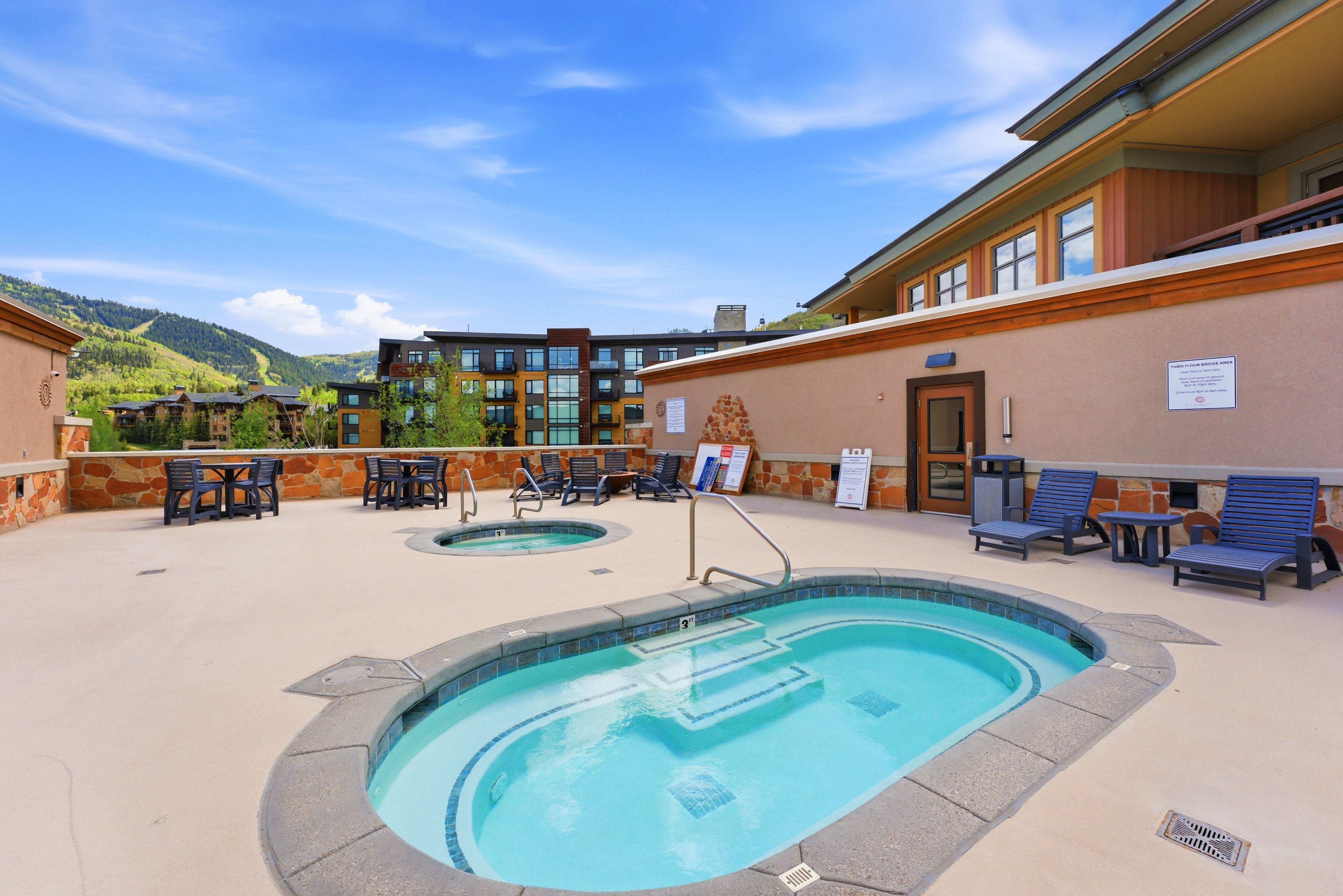 Outdoor patio area featuring two built-in spas with tiled interiors