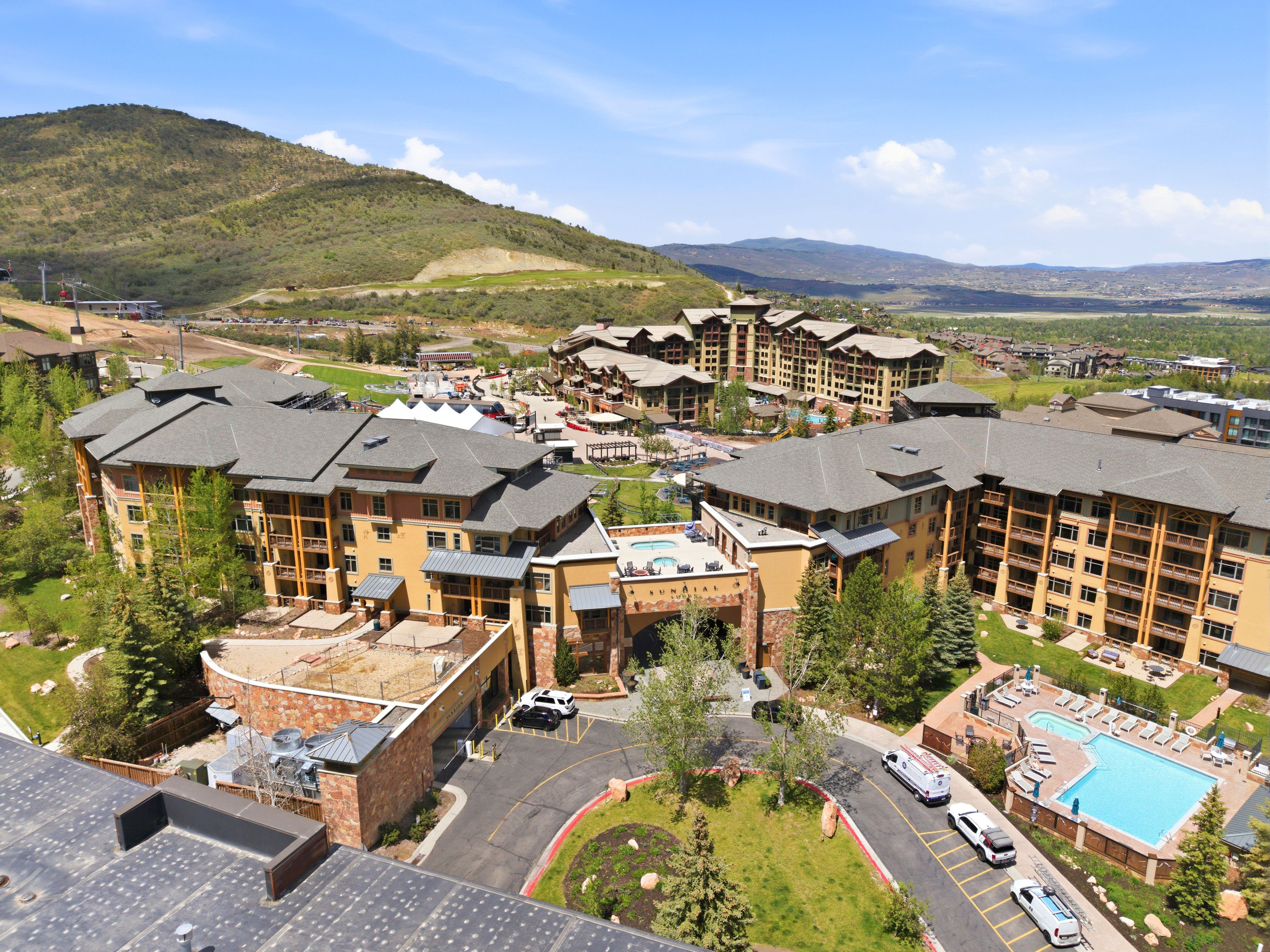 Extensive mountain resort community featuring multiple buildings with stone and stucco exteriors, private balconies, and gabled roofs